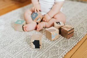 baby playing with wooden blocks